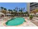 Inviting in-ground pool with cabanas and palm trees, offering a relaxing outdoor space at 2877 Paradise Rd # 104, Las Vegas, NV 89109