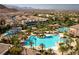Aerial view of the community pool with a water slide and palm trees at 296 Brushy Creek Ave, Las Vegas, NV 89148