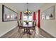 Elegant dining room with a wooden table, upholstered chairs, chandelier, and large windows at 296 Brushy Creek Ave, Las Vegas, NV 89148