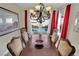 Elegant dining room with a decorative chandelier, seating for six, and a view of the pool area at 296 Brushy Creek Ave, Las Vegas, NV 89148