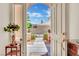 View from the inside out to a landscaped courtyard with an arched gate framed by an open front door at 296 Brushy Creek Ave, Las Vegas, NV 89148
