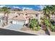 Stunning two-story home with a tile roof, mature landscaping, and a three-car garage at 296 Brushy Creek Ave, Las Vegas, NV 89148