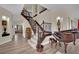 Grand foyer featuring a staircase, wood floors, an antique piano, and elegant decor at 296 Brushy Creek Ave, Las Vegas, NV 89148