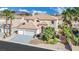 Charming two-story home with tile roof, landscaped yard, and two-car garage at 296 Brushy Creek Ave, Las Vegas, NV 89148
