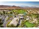 Scenic aerial view of community golf course and clubhouse with mountain views at 296 Brushy Creek Ave, Las Vegas, NV 89148