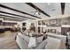 Cozy living room features dark wood beam ceiling, fireplace, and views to kitchen at 296 Brushy Creek Ave, Las Vegas, NV 89148