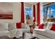 Bright living room featuring stylish sofas, decorative pillows, and natural light streaming through large windows at 296 Brushy Creek Ave, Las Vegas, NV 89148