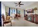 Comfortable living room with a fireplace, television, desk, and cozy seating area at 296 Brushy Creek Ave, Las Vegas, NV 89148