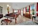 Spacious living room with a piano, wood floors, red curtains, and a sophisticated design at 296 Brushy Creek Ave, Las Vegas, NV 89148