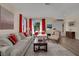 Bright living room featuring a comfortable sofa set, decorative rug, and natural light at 296 Brushy Creek Ave, Las Vegas, NV 89148
