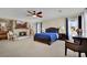 Spacious main bedroom with a fireplace, ceiling fan, large bed, and sitting area at 296 Brushy Creek Ave, Las Vegas, NV 89148