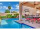 Sparkling pool surrounded by lush landscaping and an outdoor dining area at 296 Brushy Creek Ave, Las Vegas, NV 89148