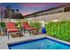 Relax poolside in this backyard featuring a sparkling pool, lounge chairs, and lush greenery at 296 Brushy Creek Ave, Las Vegas, NV 89148