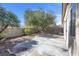 Cozy backyard with a concrete patio, brick wall, and some shade from mature trees at 3097 Quail Crest Ave, Henderson, NV 89052