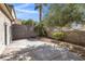 Secluded backyard featuring a concrete patio with surrounding palm trees and vegetation at 3097 Quail Crest Ave, Henderson, NV 89052