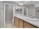 Neutral bathroom with double sinks, stone countertop, and tiled flooring at 3097 Quail Crest Ave, Henderson, NV 89052