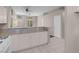 Open kitchen design with white cabinets, granite countertops, and tile flooring at 3097 Quail Crest Ave, Henderson, NV 89052