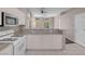 Open kitchen design with white cabinets, granite countertops, and tile flooring at 3097 Quail Crest Ave, Henderson, NV 89052