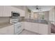 Open kitchen design with white cabinets, granite countertops, and tile flooring at 3097 Quail Crest Ave, Henderson, NV 89052