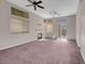 Spacious living room with fireplace, dual ceiling fans, and sliding glass door at 3097 Quail Crest Ave, Henderson, NV 89052