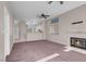 Spacious living room with fireplace, dual ceiling fans, and view into kitchen at 3097 Quail Crest Ave, Henderson, NV 89052