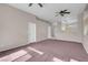 Spacious living room with fireplace, dual ceiling fans, and view into kitchen at 3097 Quail Crest Ave, Henderson, NV 89052