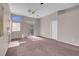 Spacious living room with fireplace, dual ceiling fans, and sliding glass door at 3097 Quail Crest Ave, Henderson, NV 89052