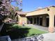 Spacious backyard featuring manicured artificial turf and a covered patio, perfect for entertaining at 32 Feather Sound Dr, Henderson, NV 89052