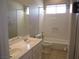 Traditional bathroom featuring a double sink vanity and a tub with shower at 32 Feather Sound Dr, Henderson, NV 89052