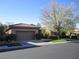 Charming single-story home featuring a well-manicured front yard and a two-car garage at 32 Feather Sound Dr, Henderson, NV 89052