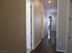 Long hallway with hardwood floors and white doors at 32 Feather Sound Dr, Henderson, NV 89052
