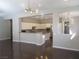 Modern kitchen with white cabinets, granite countertops, stainless steel appliances, and a breakfast bar at 32 Feather Sound Dr, Henderson, NV 89052