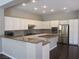 Beautiful kitchen featuring white cabinetry, stainless steel appliances, and granite countertops at 32 Feather Sound Dr, Henderson, NV 89052
