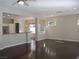 Open-concept living room showcasing hardwood floors, modern lighting, and seamless flow to the kitchen at 32 Feather Sound Dr, Henderson, NV 89052