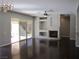 Spacious living room featuring hardwood floors, a fireplace, and backyard access at 32 Feather Sound Dr, Henderson, NV 89052