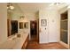 Bathroom with double sinks, a large mirror, and wood-look flooring at 325 Wild Plum Ln, Las Vegas, NV 89107
