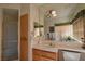 Well-lit bathroom with a large mirror over the vanity and a tiled shower enclosure at 325 Wild Plum Ln, Las Vegas, NV 89107