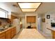 Bright kitchen featuring a large island, white appliances, and wood cabinets at 325 Wild Plum Ln, Las Vegas, NV 89107