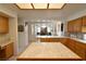 Bright kitchen with an island, white countertops and wooden cabinetry at 325 Wild Plum Ln, Las Vegas, NV 89107