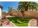 Inviting backyard features lush artificial turf, desert landscaping, and a serene outdoor setting at 3305 Alcudia Bay Ave, Las Vegas, NV 89141