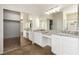 Primary bathroom boasting dual sinks, granite countertop, tile floor and large closet at 3305 Alcudia Bay Ave, Las Vegas, NV 89141