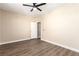 Bedroom featuring wood-look flooring, a ceiling fan, and door at 3305 Alcudia Bay Ave, Las Vegas, NV 89141