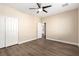 Bedroom featuring wood-look flooring, a ceiling fan, and closet with sliding doors at 3305 Alcudia Bay Ave, Las Vegas, NV 89141