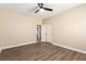 Bright bedroom with wood-look flooring, a ceiling fan, and closet with double doors at 3305 Alcudia Bay Ave, Las Vegas, NV 89141