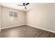 Cozy bedroom featuring wood-look floors, a ceiling fan, and a bright window at 3305 Alcudia Bay Ave, Las Vegas, NV 89141