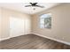 Bedroom featuring wood-look flooring, a ceiling fan, arched window and closet with sliding doors at 3305 Alcudia Bay Ave, Las Vegas, NV 89141