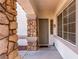 Inviting front entryway features a stone column and a neutral-colored front door at 3305 Alcudia Bay Ave, Las Vegas, NV 89141