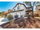 Inviting two-story home featuring a three-car garage, stone detailing, and desert landscaping in front at 3305 Alcudia Bay Ave, Las Vegas, NV 89141