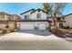A two-story home boasts a double garage and well-maintained landscaping, set in a friendly neighborhood at 3305 Alcudia Bay Ave, Las Vegas, NV 89141