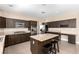 Spacious kitchen with dark cabinetry, granite countertops and island with seating at 3305 Alcudia Bay Ave, Las Vegas, NV 89141